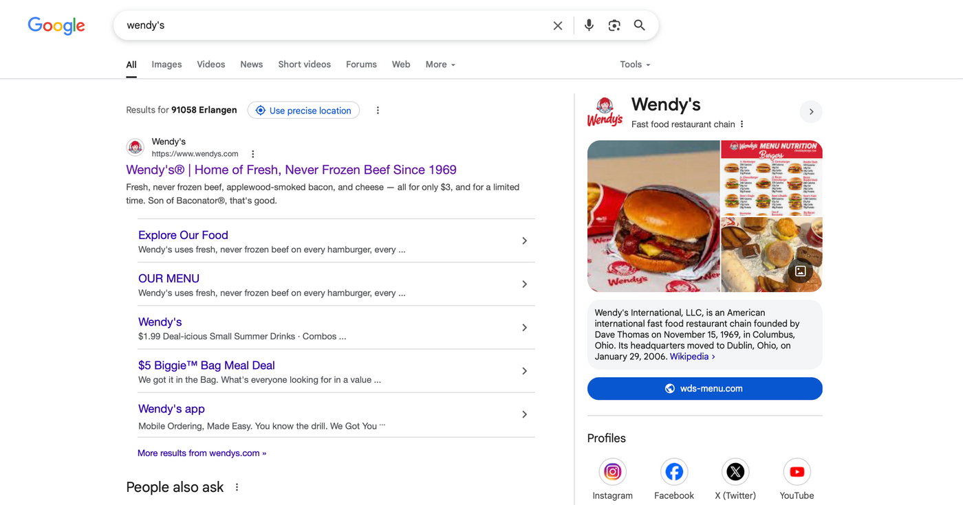 Google search results for "Wendy's." Includes a description of fresh beef in purple text, menu links, and a burger image on the right.