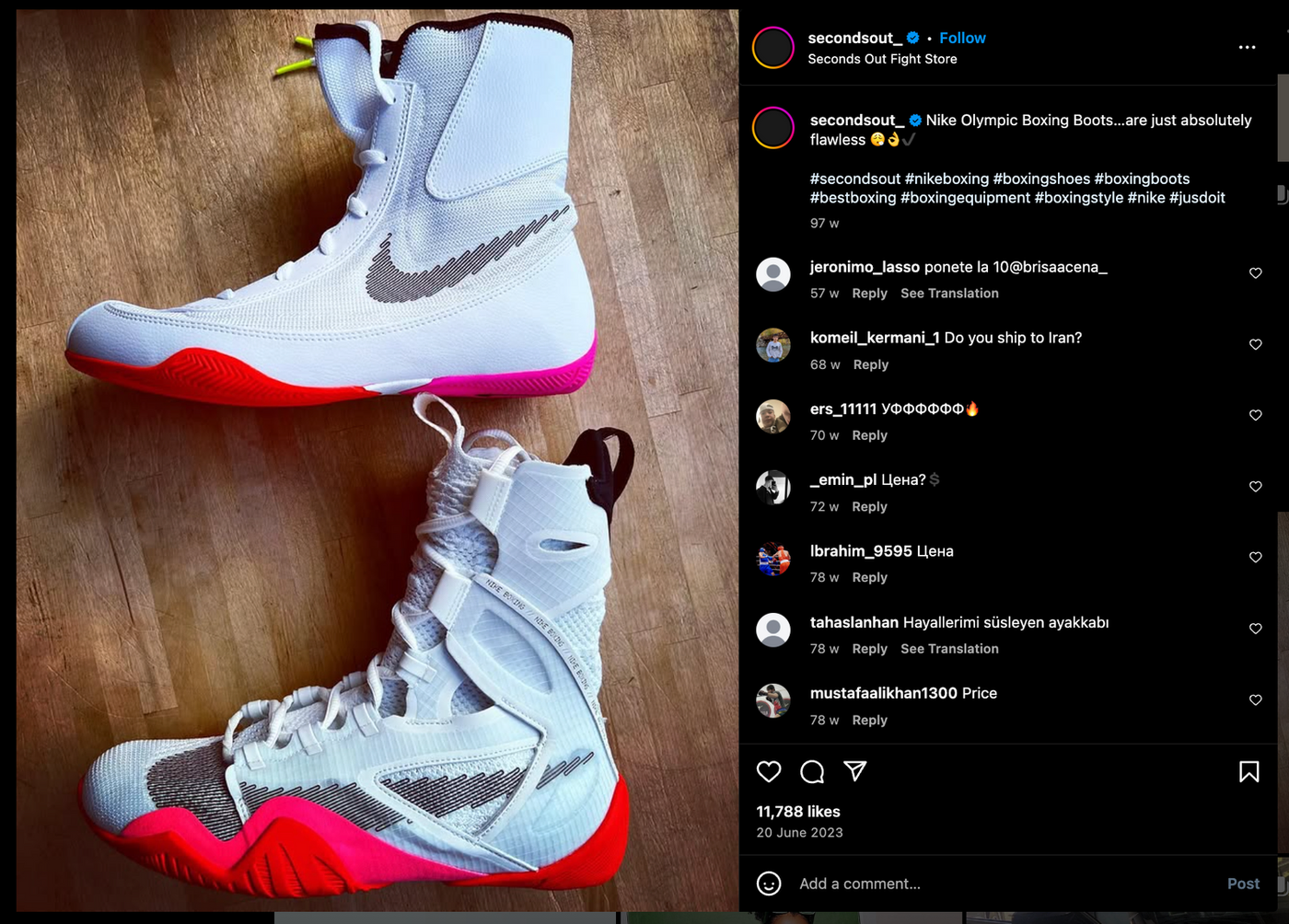 Two white Nike boxing boots on wooden floor, featuring black logos and vibrant red and pink soles. Instagram post with likes and comments.